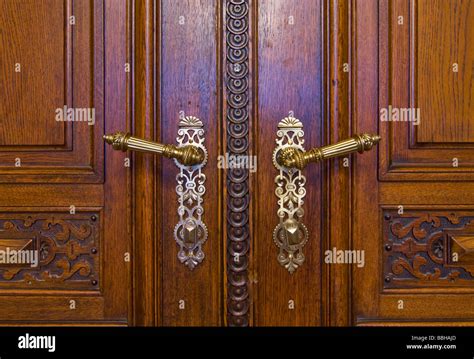 Carved Wooden Door With Ornate Handles Stock Photo Alamy