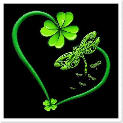 Four Leaf Clovers And A Dragon Fly In The Shape Of A Heart