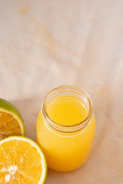 Premium Photo Glass Jar With Orange Juice And Oranges On The Side