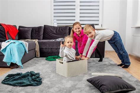 Three Children Are Having Fun In Room And Making Mess Happy Childhood