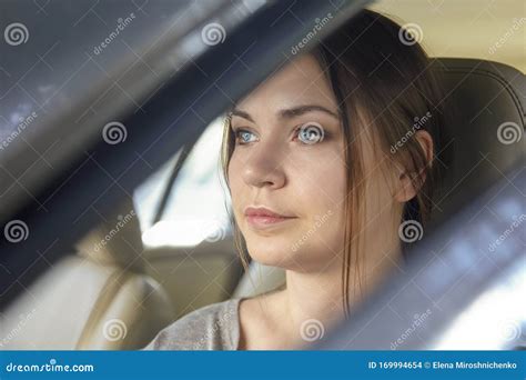 Young Attractive Caucasian Woman Behind The Wheel Driving A Car With