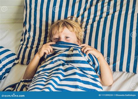 The Cute Boy Woke Up In His Bed Children Sleep Concept Stock Image