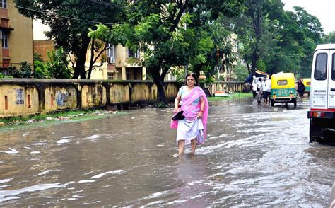 People Wade Through Water Logged Roads