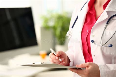 Hands Of Doctor Hold Clipboard And Write Down Results Of Examination