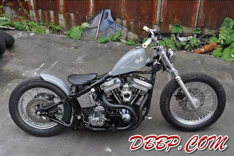 Gray Evo Softail Bobber With Short Blacked Out Exhaust And Mid Controls