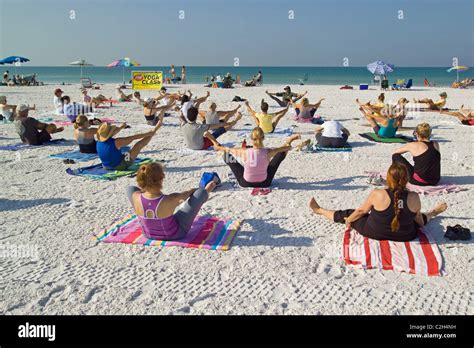 Yoga classes are held on the white sand beach of Siesta Key, a resort ...