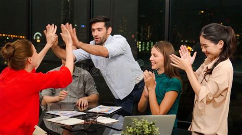 Group Of Businesspeople Clap Hands And Gives High Five Together