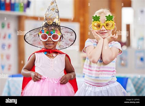 Having Fun In Class Shot Of Two Girls Playing Dress Up In Class Stock