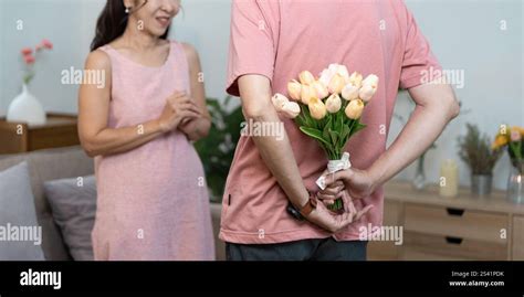 Romantic Surprise: Man Hiding Tulips Behind His Back for a Heartwarming ...