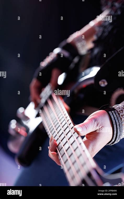 Female Musician Playing Electric Guitar During A Performance In A Close