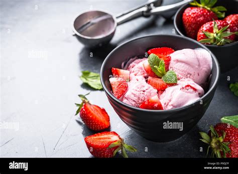 Strawberry Ice Cream With Fresh Berries In Black Bowl Close Up Stock