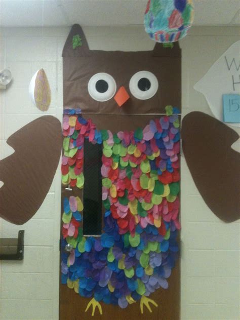 An Owl Made Out Of Paper Plates On Top Of A Door Decorated With Confetti