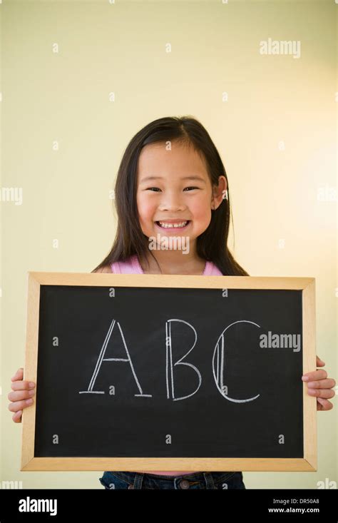 Korean Girl Holding Chalkboard With Abc Text Stock Photo Alamy