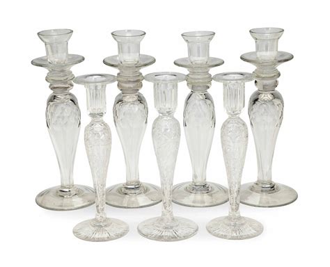 A Set Of Four English Colorless Glass Candlesticks And Three Etched