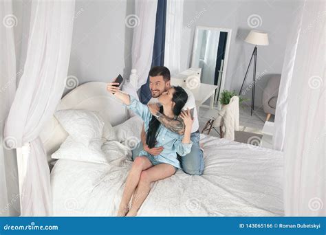 Young Beautiful And Loving Couple Take Selfie Picture On Smartphone