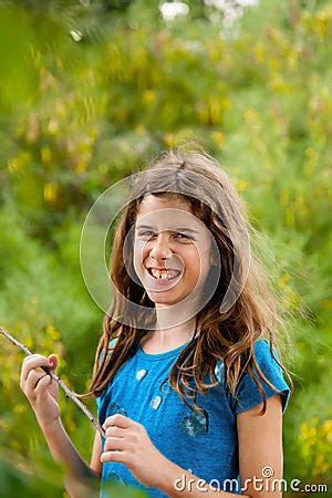 Laughing Tween Girl With Messy Hair Holding A Stick Stock Photo ...