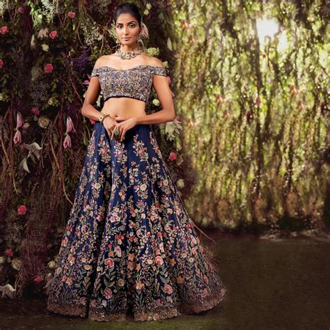 A Deep Blue Raw Silk Panelled Lehenga With Contrast Embroidery Done In Overlayed Sequins Glass