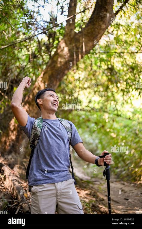 Portrait Excited And Active Asian Male Traveler Or Trekker With