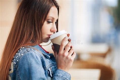 Close Up Beautiful Girl In The Denim Jacket Drinking Coffee In The