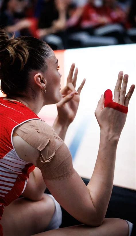 A Woman With Bandages On Her Arm Sitting Down