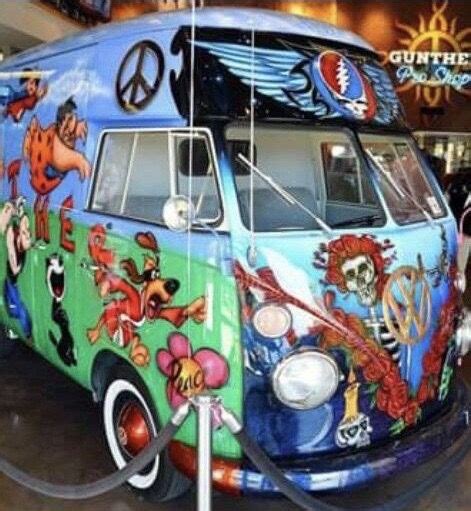 An Old Vw Bus Painted With Cartoon Characters