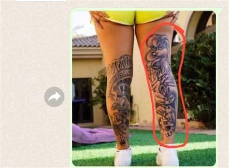 A Woman S Legs With Tattoos On Them And An Orange String Attached To