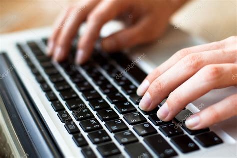 Photo Of Hands Typing Text On A Laptop Keyboard Stock Photo