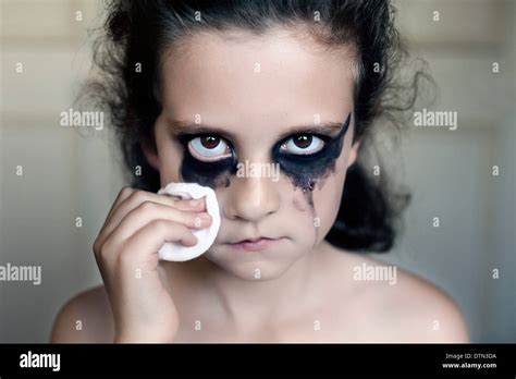 A young girl crying with black makeup with a gaze looking towards Stock Photo: 66846566 - Alamy