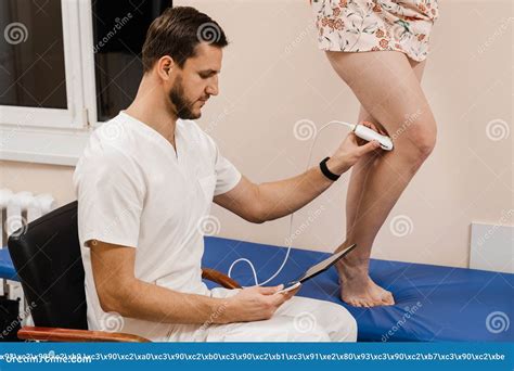 Vascular Surgeon Examines Veins And Arteries Of Legs Of Girl In Medical