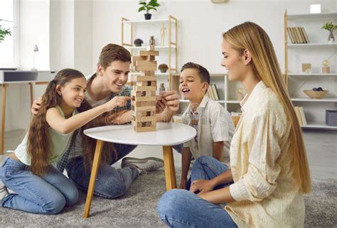 Familia Feliz Jugando Juntos Al Juego De Mesa De Jenga En Casa Imagen