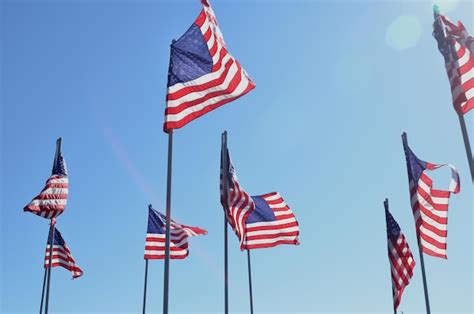 Premium Photo | American flags blowing in wind