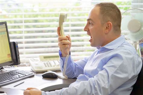 Businessman At His Desk Throws Documents And Papers Into The Air Stock