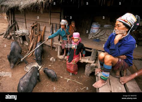 Indigenous Women With Her Children In Front Of House Hi Res Stock