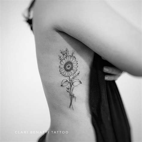 A Woman With A Sunflower Tattoo On Her Back