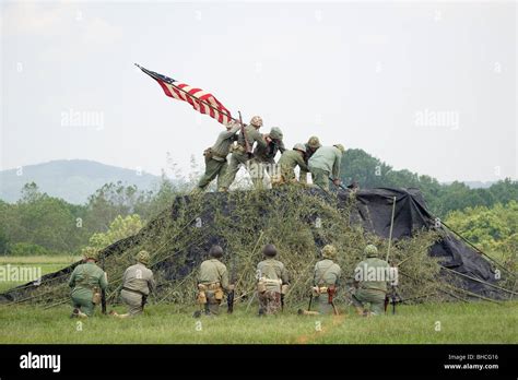 A World War Ii Reenactment Of Us Marines Raising The American Flag On