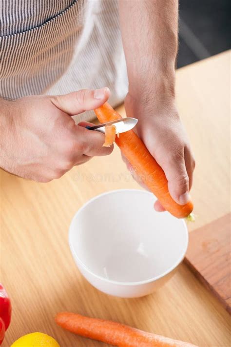 Man Peeling Carrot In Kitchen Stock Image Image Of Cook Vegetarian