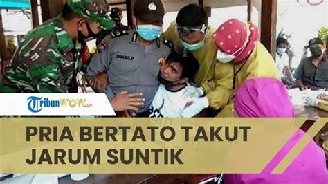 Pria Bertato Bikin Heboh Harus Dipegangi Banyak Orang Saat Vaksin