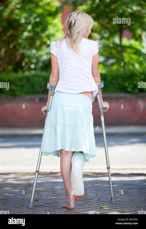 Woman Walking On Crutches Stock Photo Royalty Free Image 24588441 Alamy