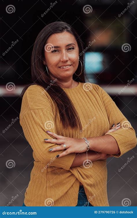 A Powerful Portrait Of A Businesswoman Standing Confidently With Her Arms Crossed Representing