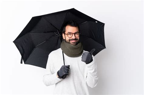 Premium Photo Man Holding An Umbrella Over Isolated Wall