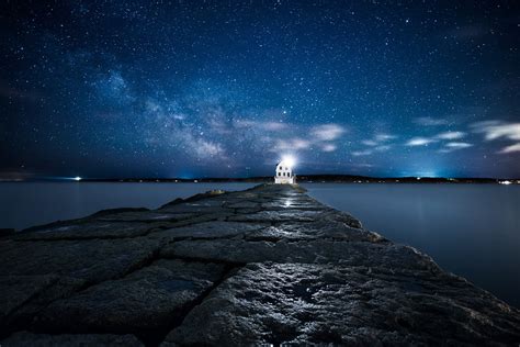 Online Crop Lighted White Lighthouse On The Edge Of Rock Pavement