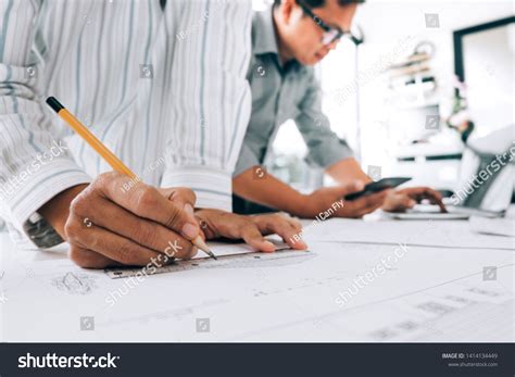 Engineers Pointing Building On Blueprint Drawing Stock Photo 1414134449