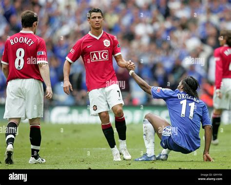 Manchester uniteds cristiano ronaldo gives chelseas didier drogba a hand hi-res stock ...