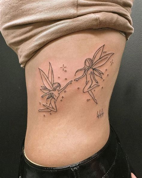 Fine Line Fairies Tattoo Located On The Rib