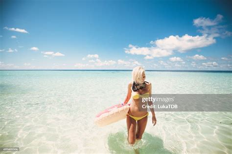 Blonde Woman Standing In Shallow Water With Snorkel Equipment Maldives