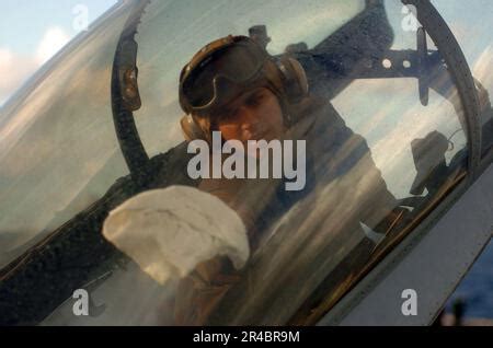 US Navy A Plane Captain Cleans The Canopy Of An F 14D Tomcat Prior To