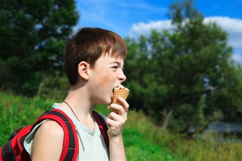 Premium Photo Boy Eats Ice Cream