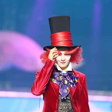 A Man With Red Hair Wearing A Top Hat And Holding His Hands To His Face