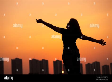 Silhouette Success Woman Hands Up With Sunset Sky Background Stock