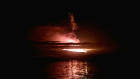wolf volcano  galapagos islands erupts spewing lava  clouds  ash